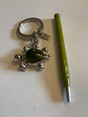 Coach Silver Turtle Keychain with a Green inset and a  Green Coach Pen